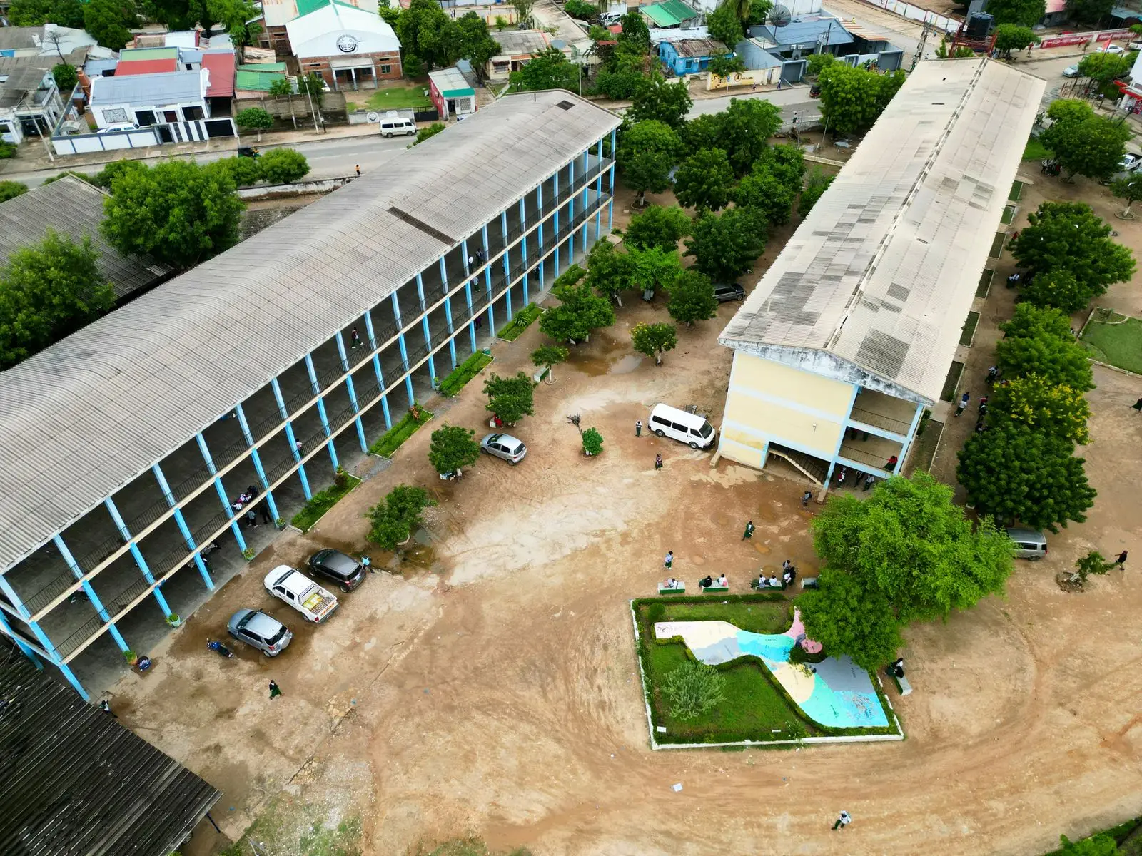 Aerial view of a school compound with classroom blocks around a central courtyard
